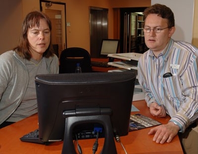 Get accurate records affordably Two librarians using computer