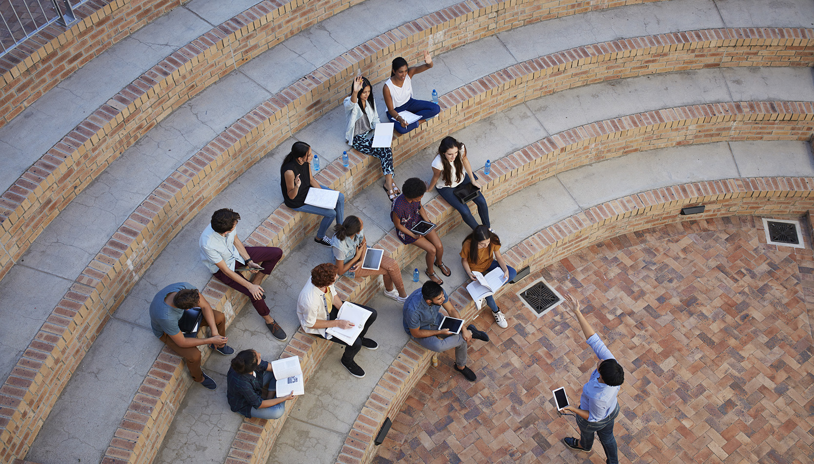 A group of students in an ampitheatre style classroom